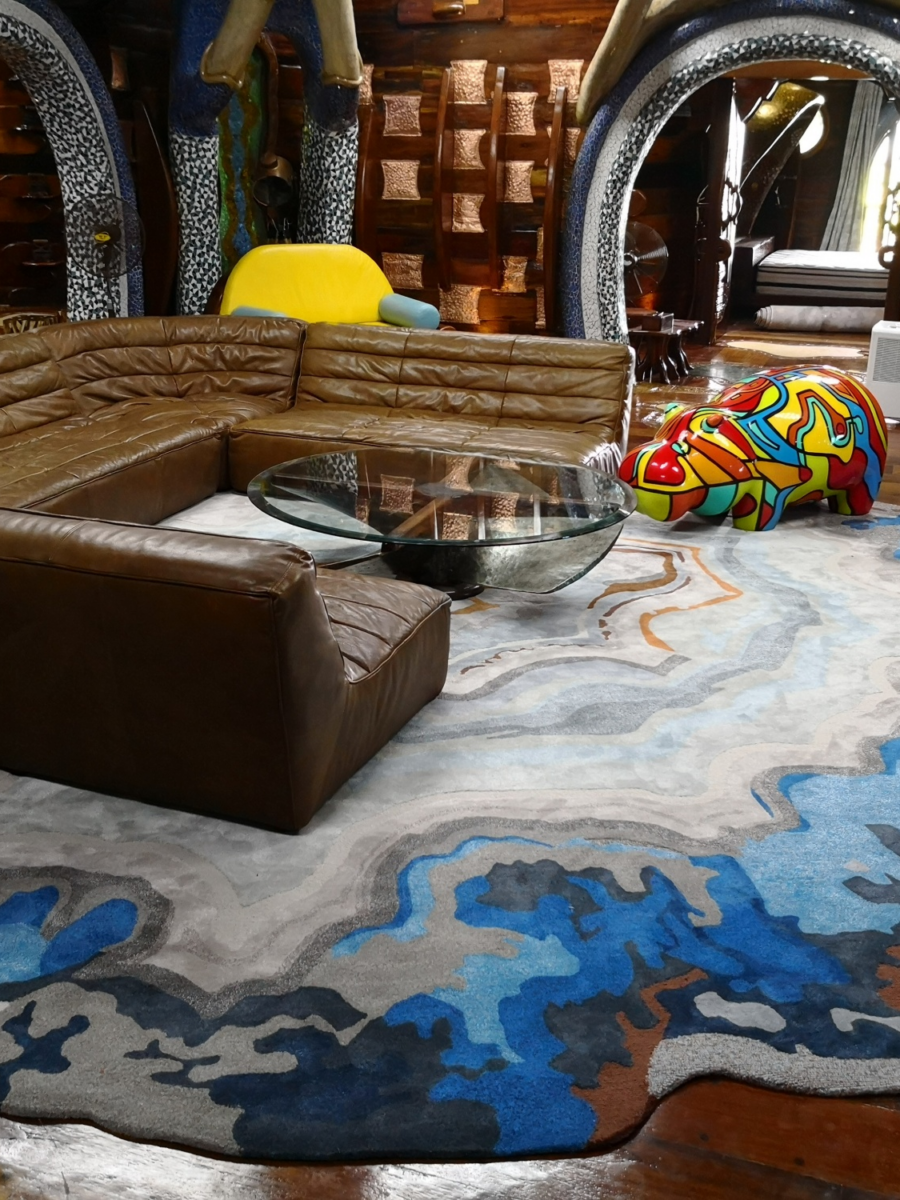 Family living room with warm beige floor tiles and a dark low sofa.